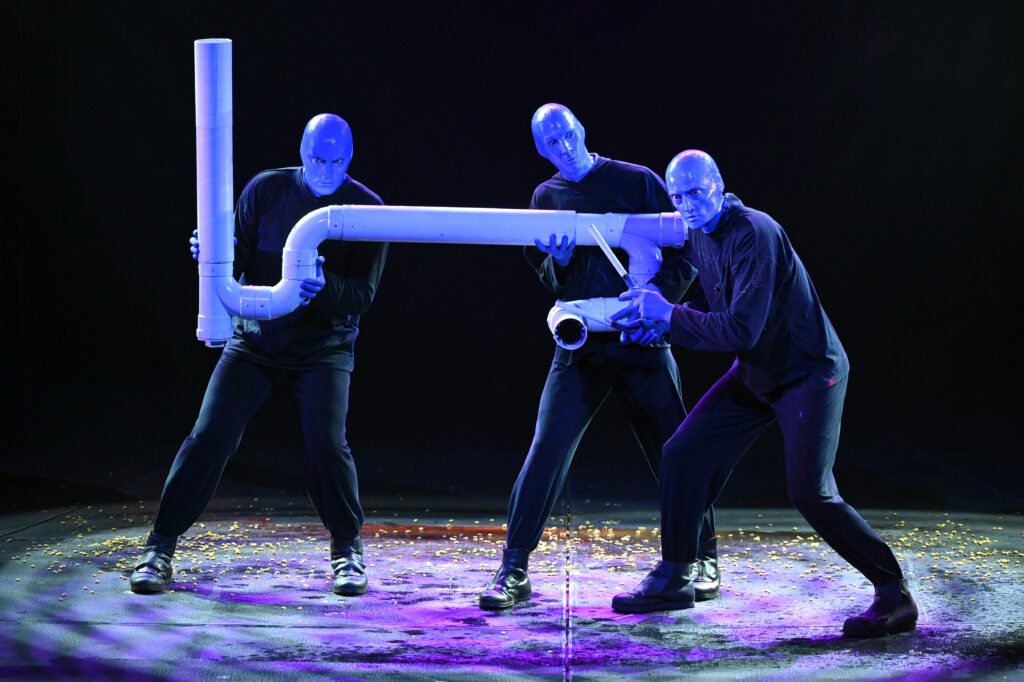 Blue Man Group performs with a PVC Pipe