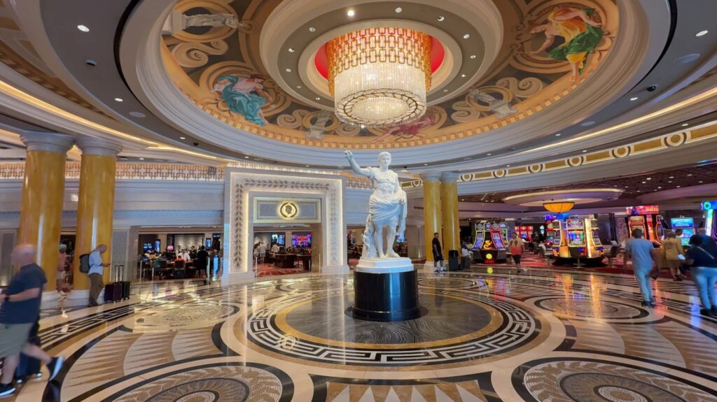 A statue underneath a chandelier in the new entryway.