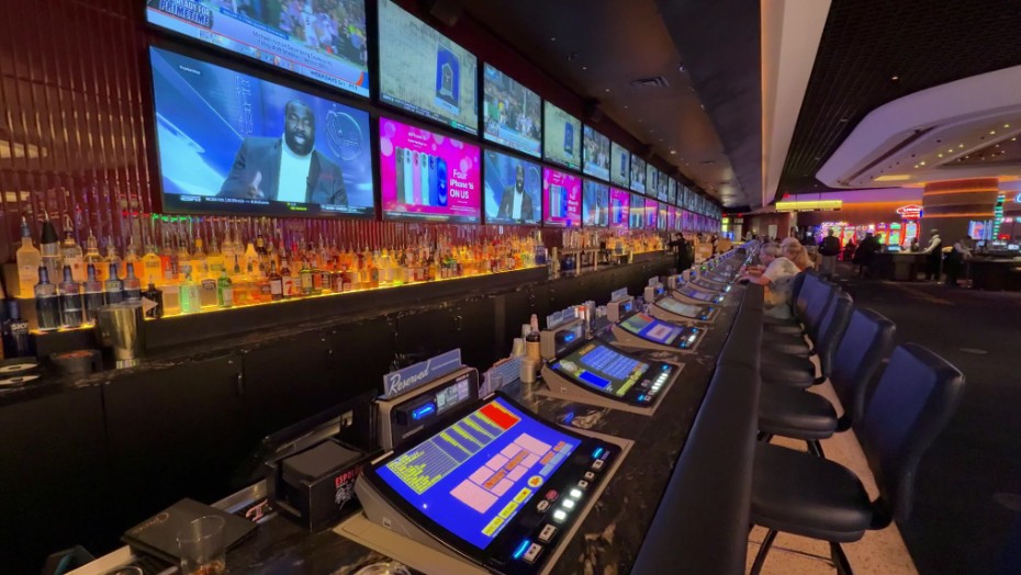 A row of video poker machines that extends into the distance at Circa's Megabar.