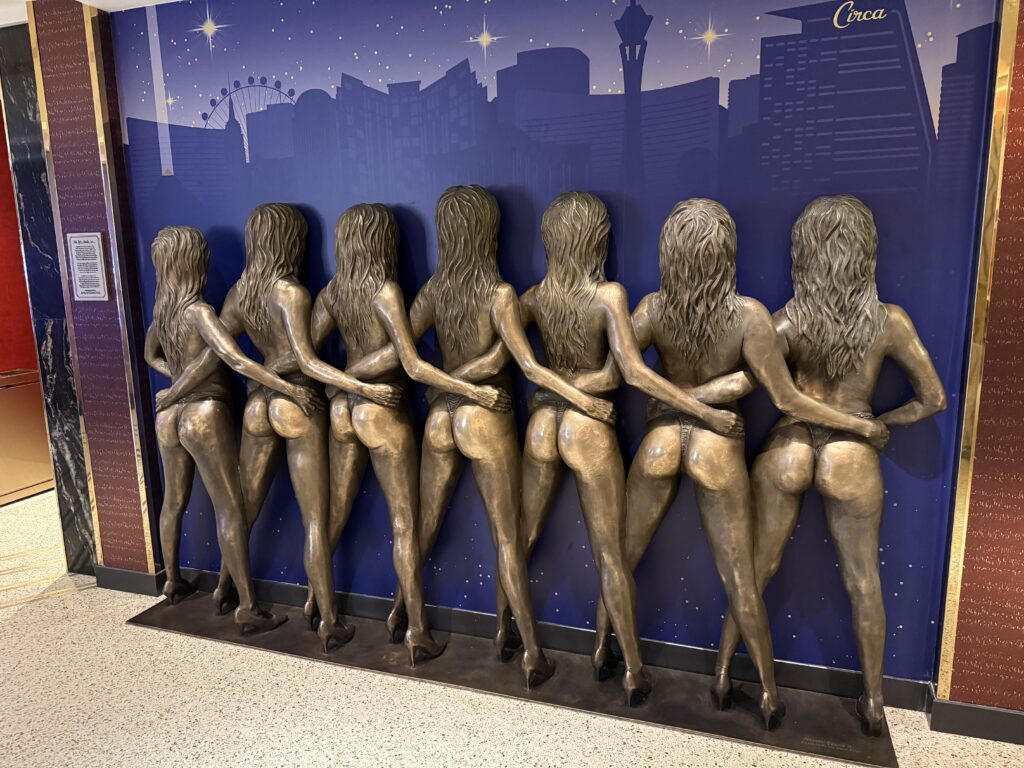 Bronze statue depicting 7 showgirls standing side by side.