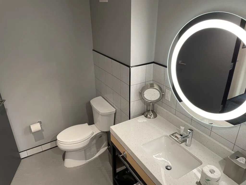 Sink and toilet in a Downtown Grand Superior hotel room.