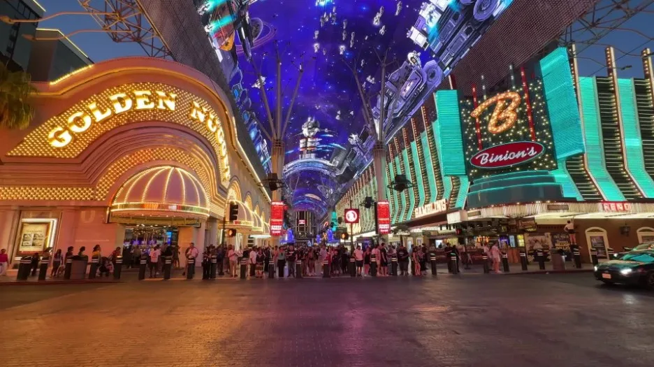 Golden Nugget and Binion's illuminated at night, with the overhead canopy playing video content.