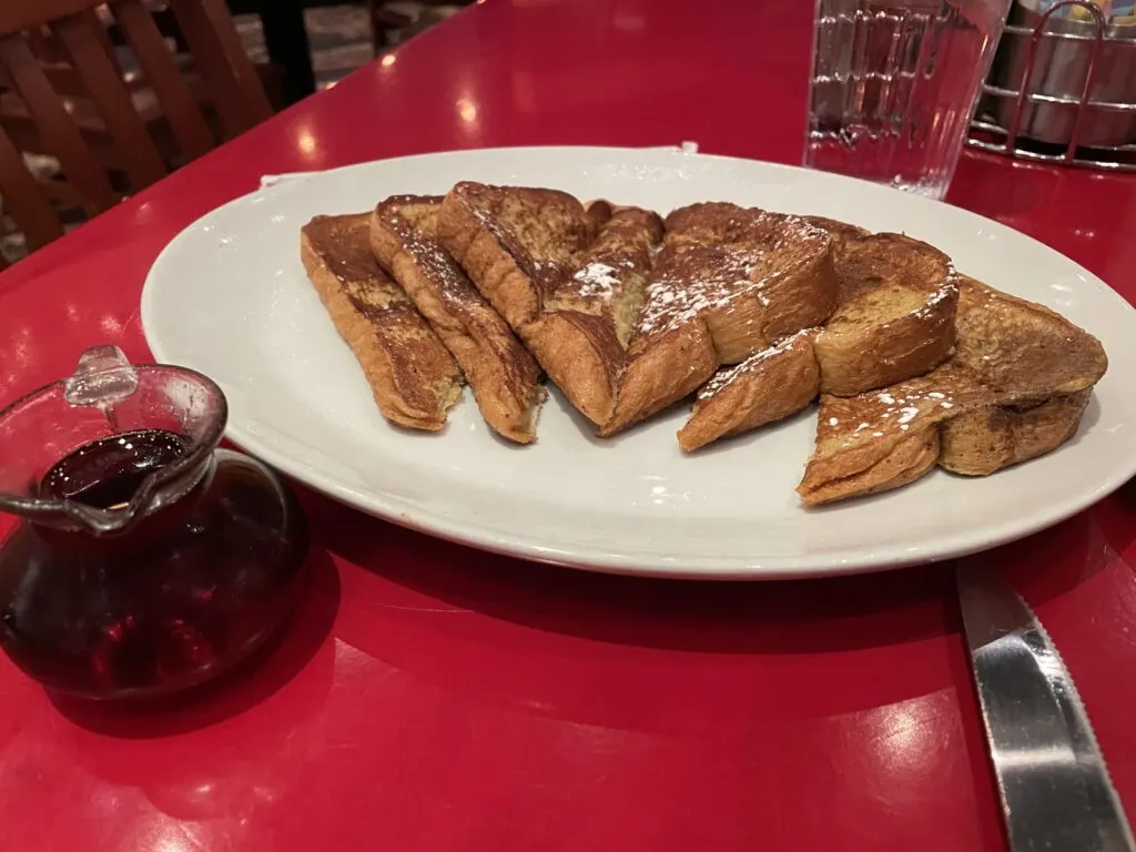 French Toast stacked on a plate.