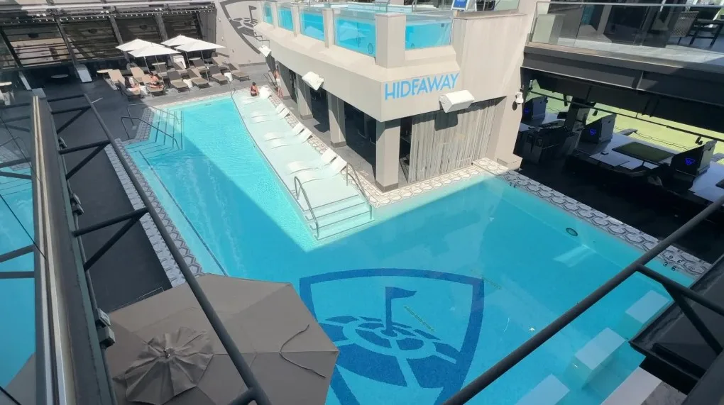 A two level pool photographed from above. The bottom pool has the Topgolf logo on the floor.