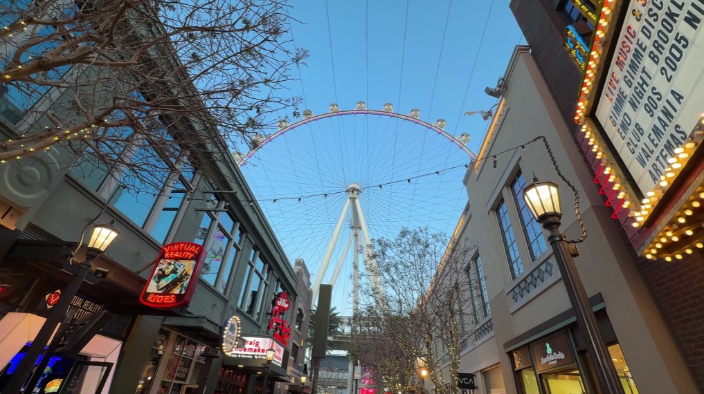 LINQ Promenade shops on either side, and the High Roller Wheel in the background.