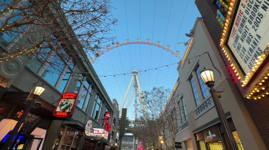 LINQ Promenade shops on either side, and the High Roller Wheel in the background. 