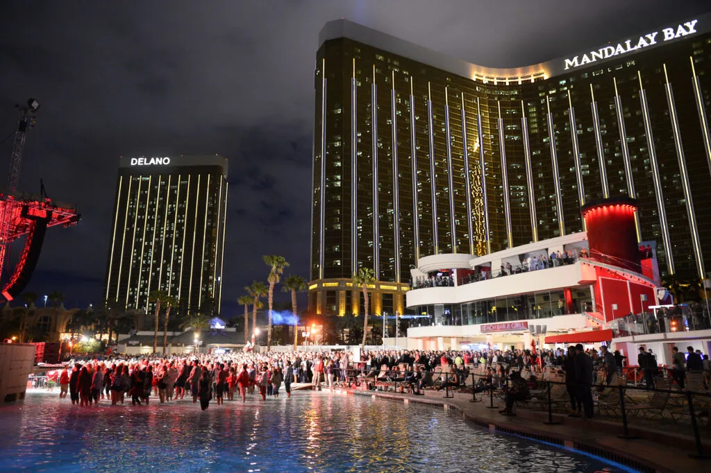 Crowd gathers around Mandalay's pool for a concert at night