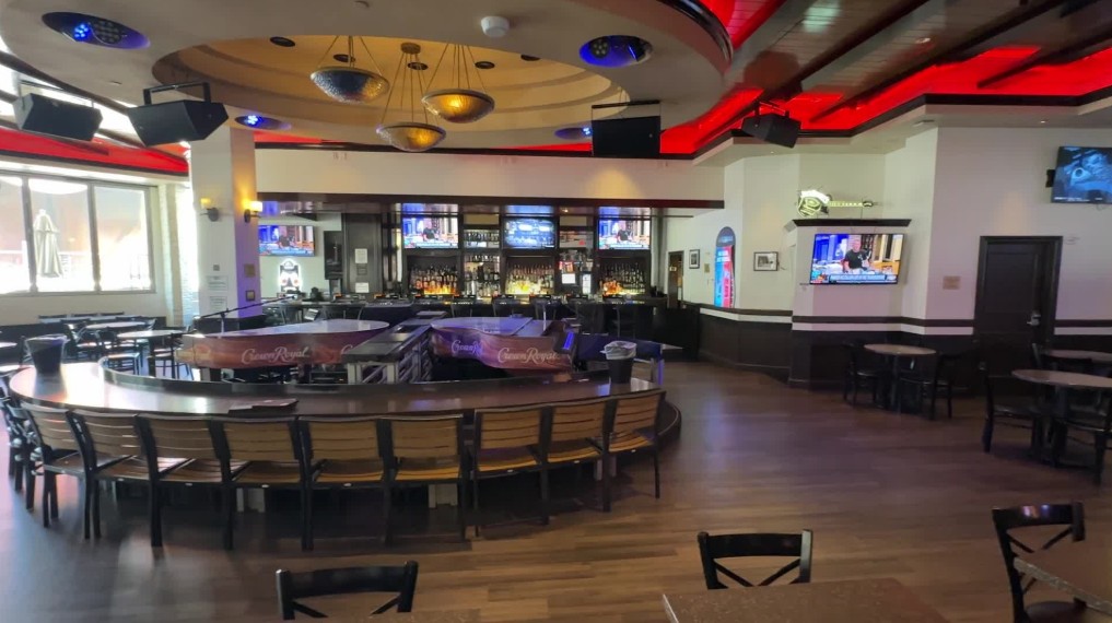 Inside the Piano bar, with seating and 2 pianos in the  foreground. 