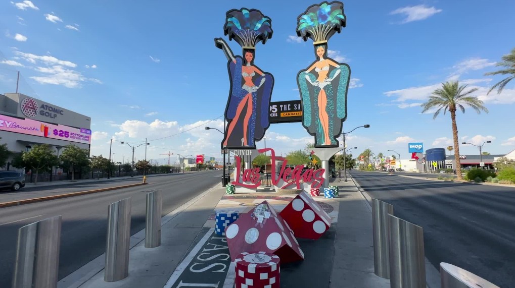 A photo opportuinity with dice in the foreground and two giant showgirls behind. 