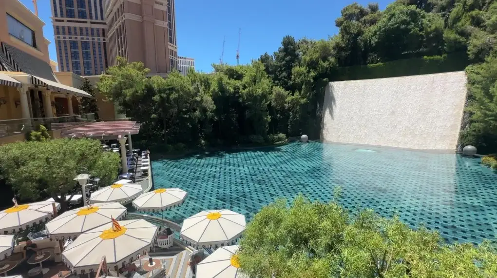 Wynn's Lake of Dreams stage, which is a pond with a waterfall cascading down a wall in the background.