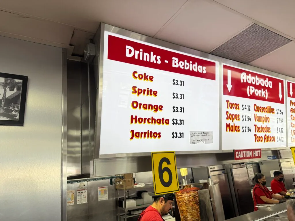 A menu board showing drinks cost $3.31. 