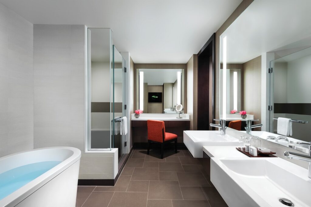A bathtub and dual sink vanity in a bathroom.