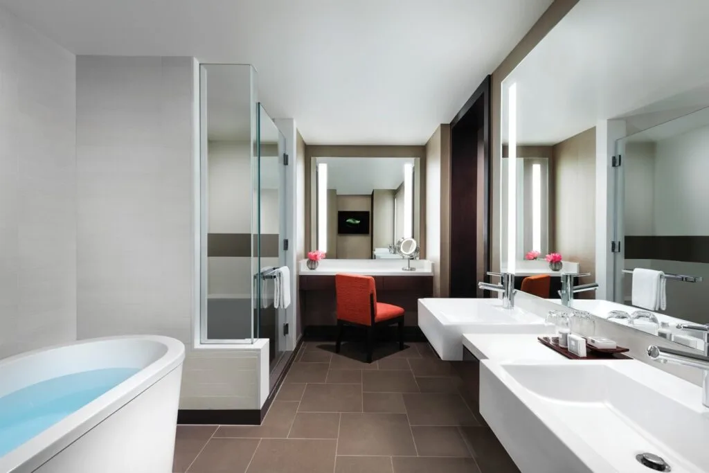 A bathtub and dual sink vanity in a bathroom. 