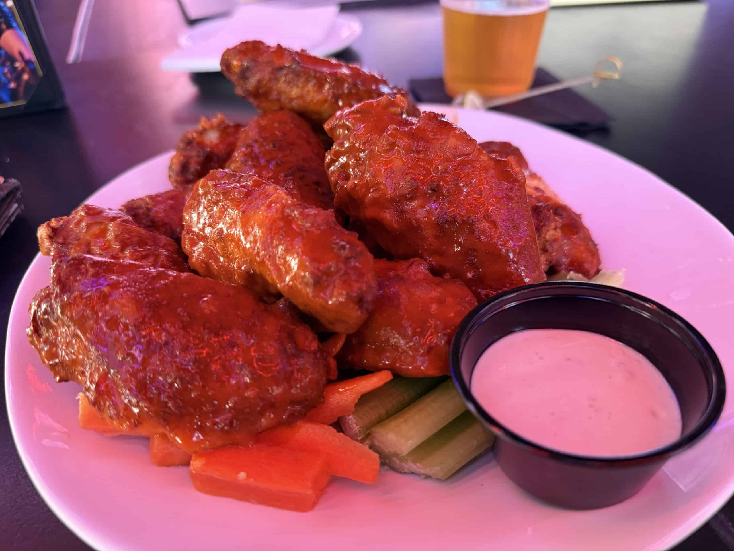 A pile of bone in buffalo wings on a plate at bottled blonde.