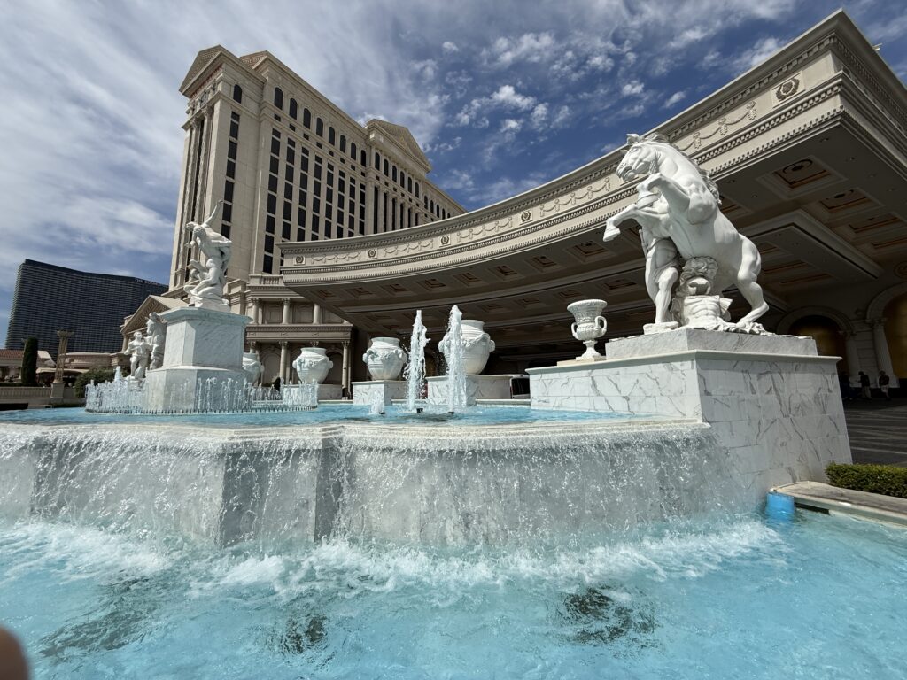 A roman themed fountain in front of a hotel tower at Caesars Palace Las Vegas.
