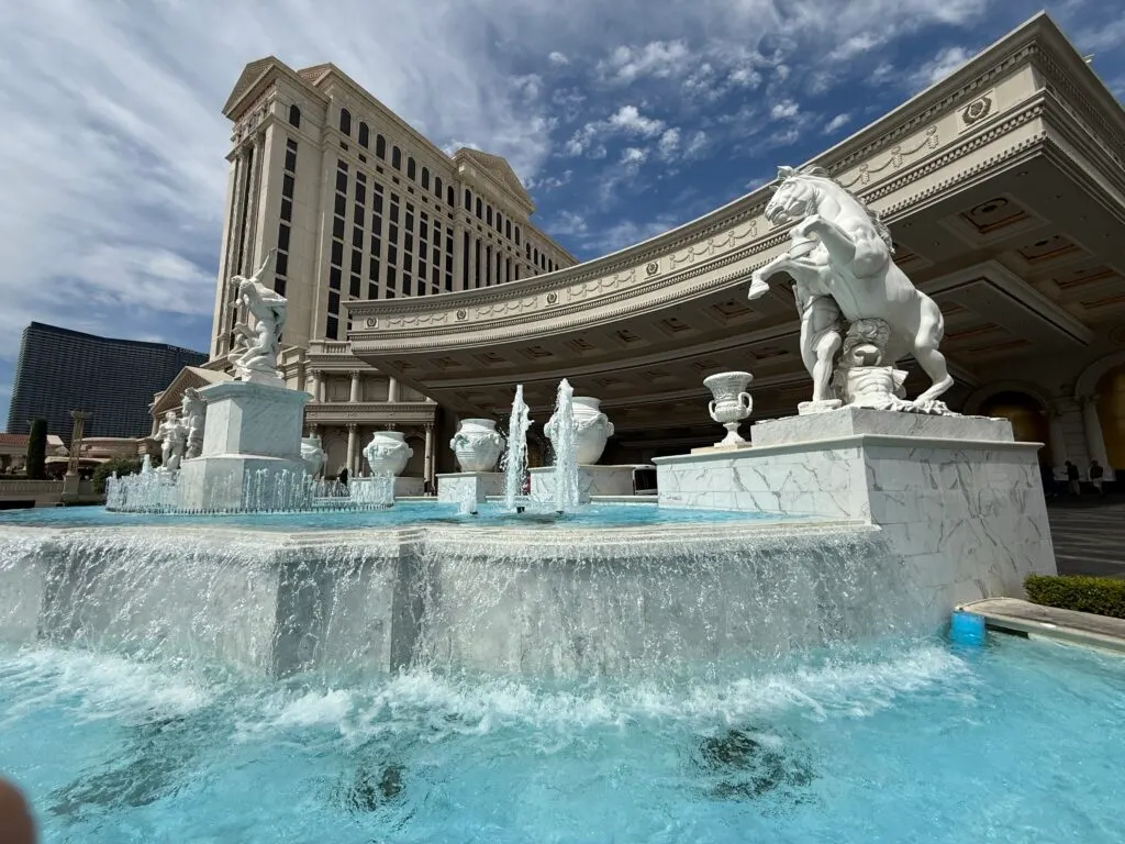 A roman themed fountain in front of a hotel tower at Caesars Palace Las Vegas.