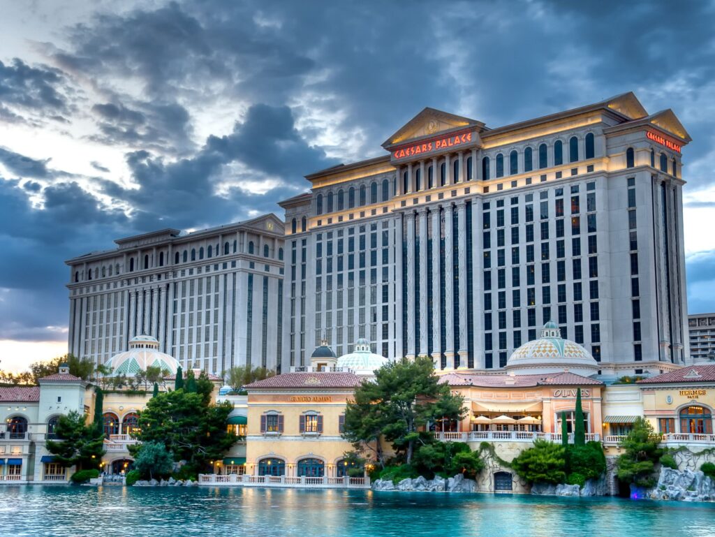 Exterior of Caesars Palace's hotel tower with Bellagio's man makde lake in the foreground