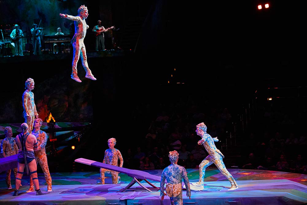 Acrobatic performers flying through the air in Mystere