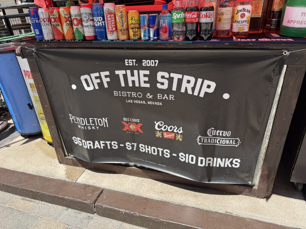 An outdoor stand along the LINQ promenade advertising drink deals. 