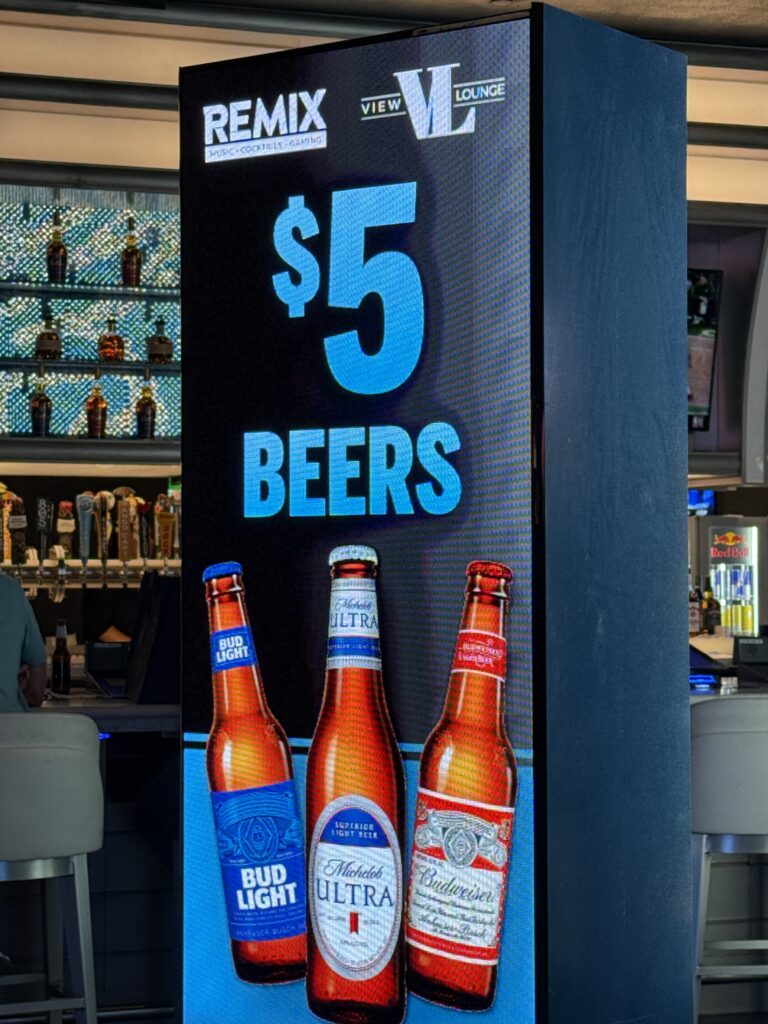 A sign advertising $5 bottles of beer at STRAT. 