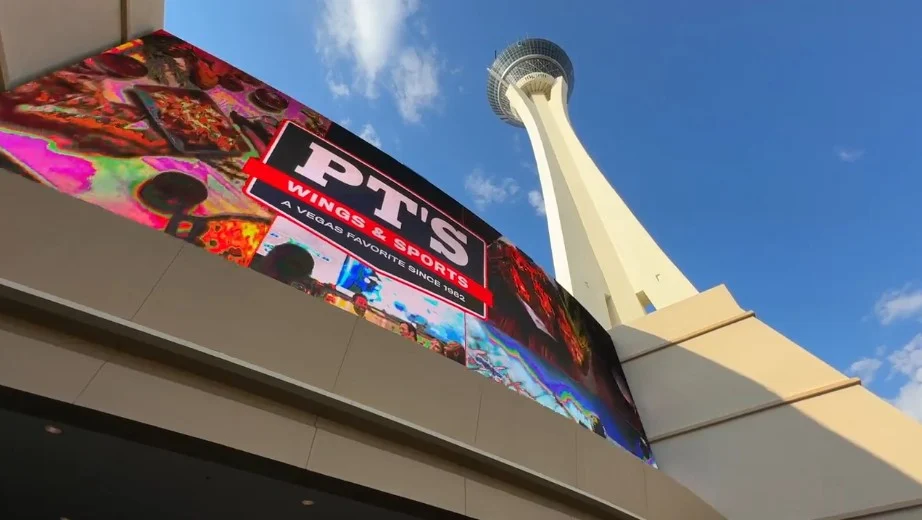 Exterior of STRAT's skypod with a digital PT's billboard on the hotel's facade. 
