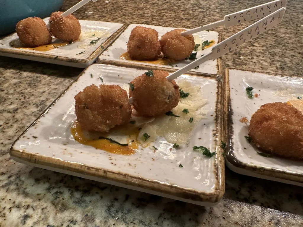 2 Stuffed Risotto Balls on a skewer. 