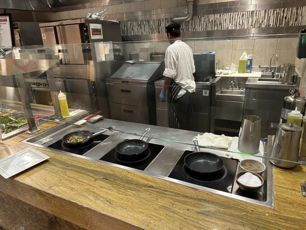 Omelette Station at Wicked Spoon with a chef working several pans at once.