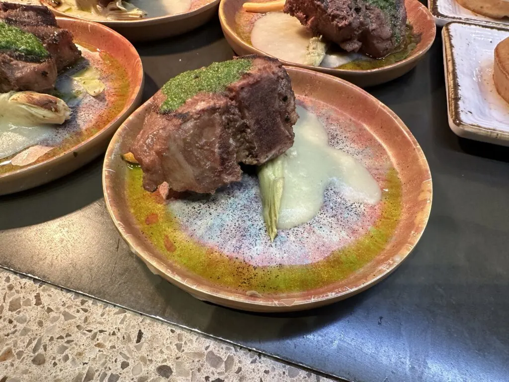 Wood Grilled Tbone single serving on a small plate at the Bacchanal Buffet. 