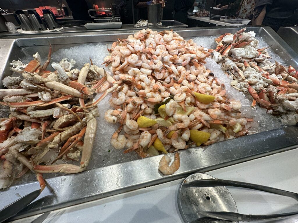Chilled crab legs, shrimp, and crab claws served on ice.