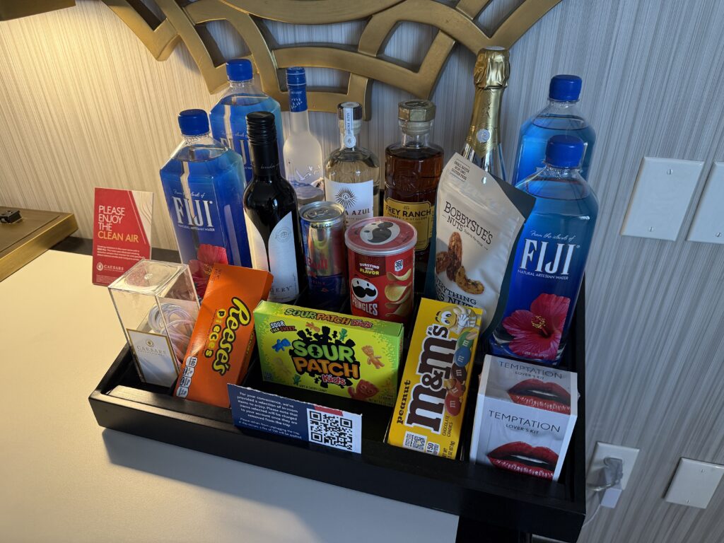Dry minibar stocked with bottled water and candy. 