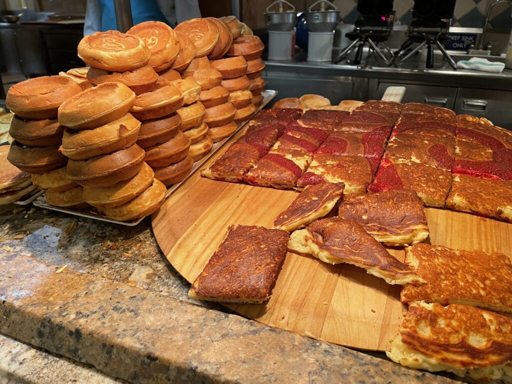 Waffles and a massive pancake cut into square pieces