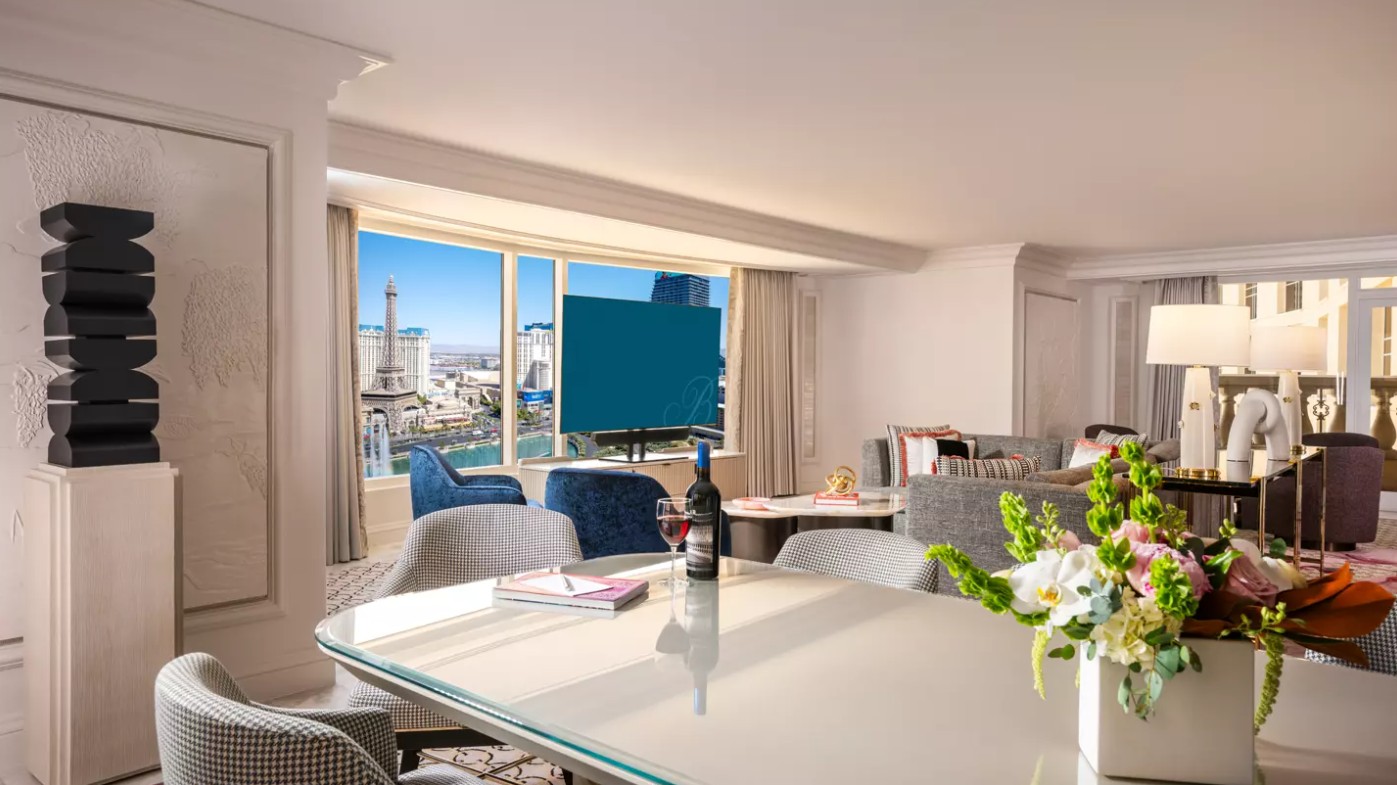 A dining and living area, with a window in the background overlooking the Strip.