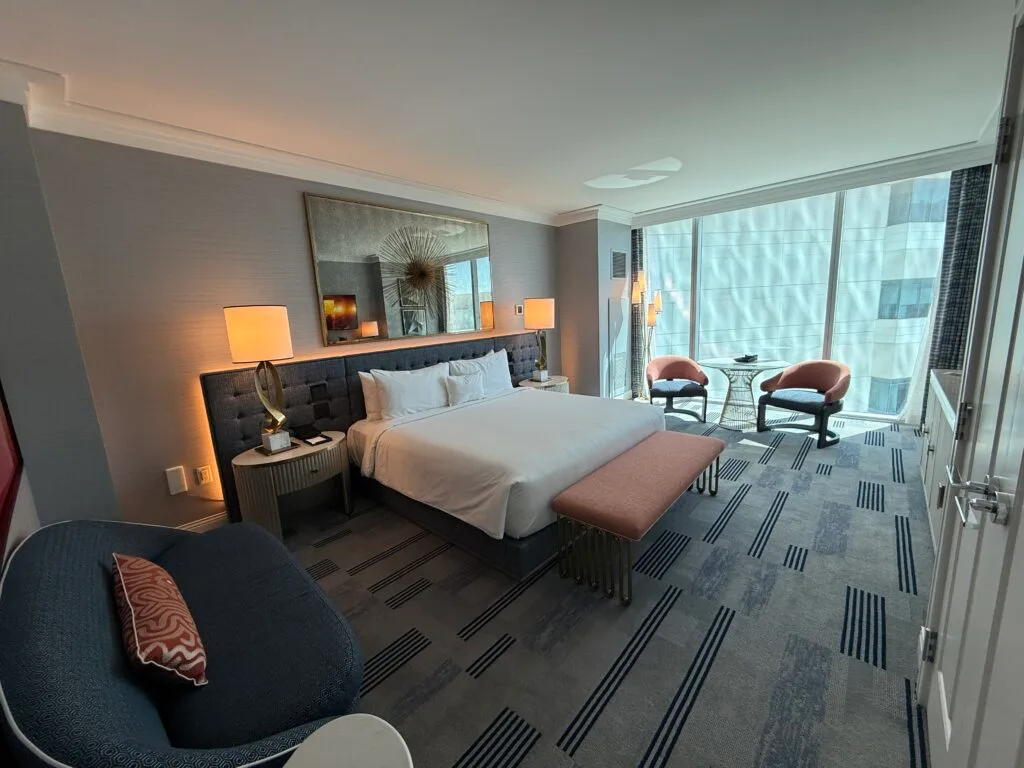 A king bed with backlit headboard. 