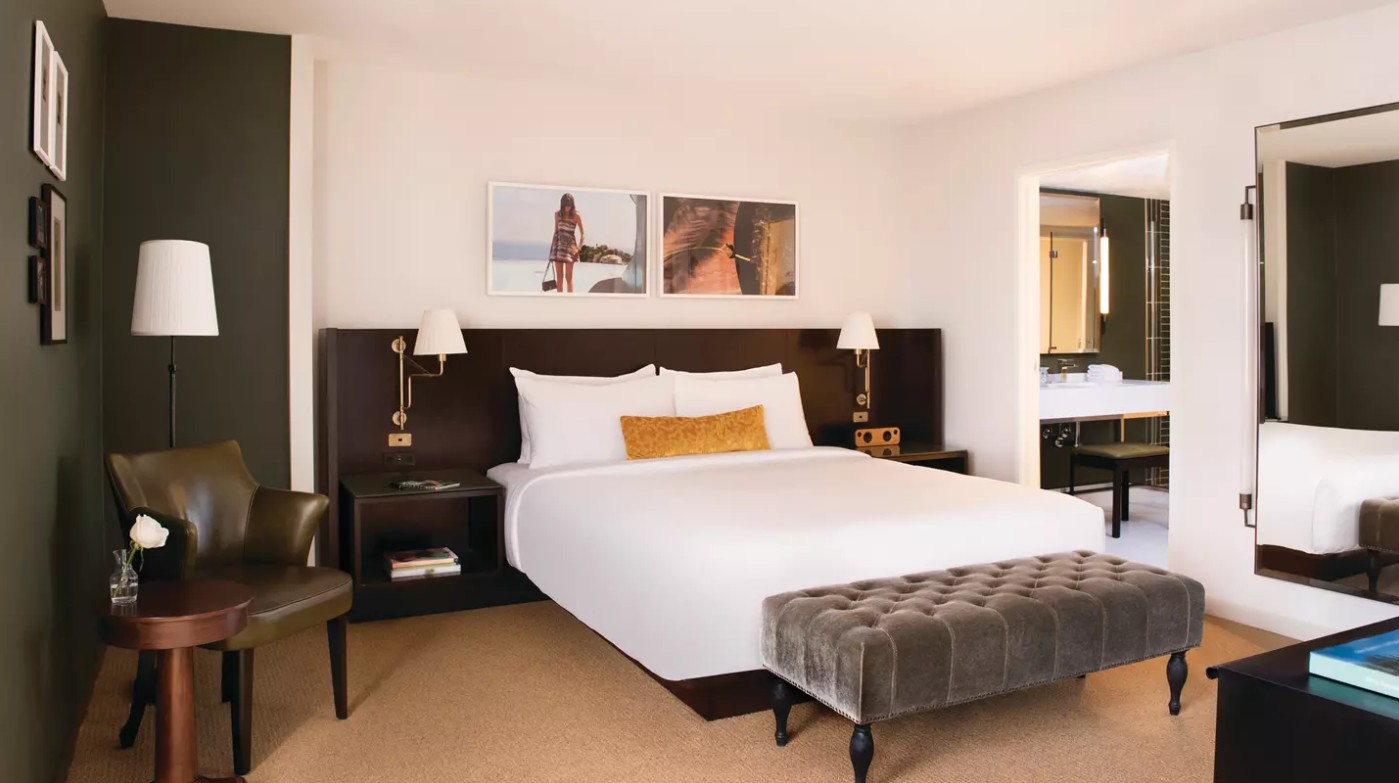 A king bed with an entryway to the bathroom to the right.