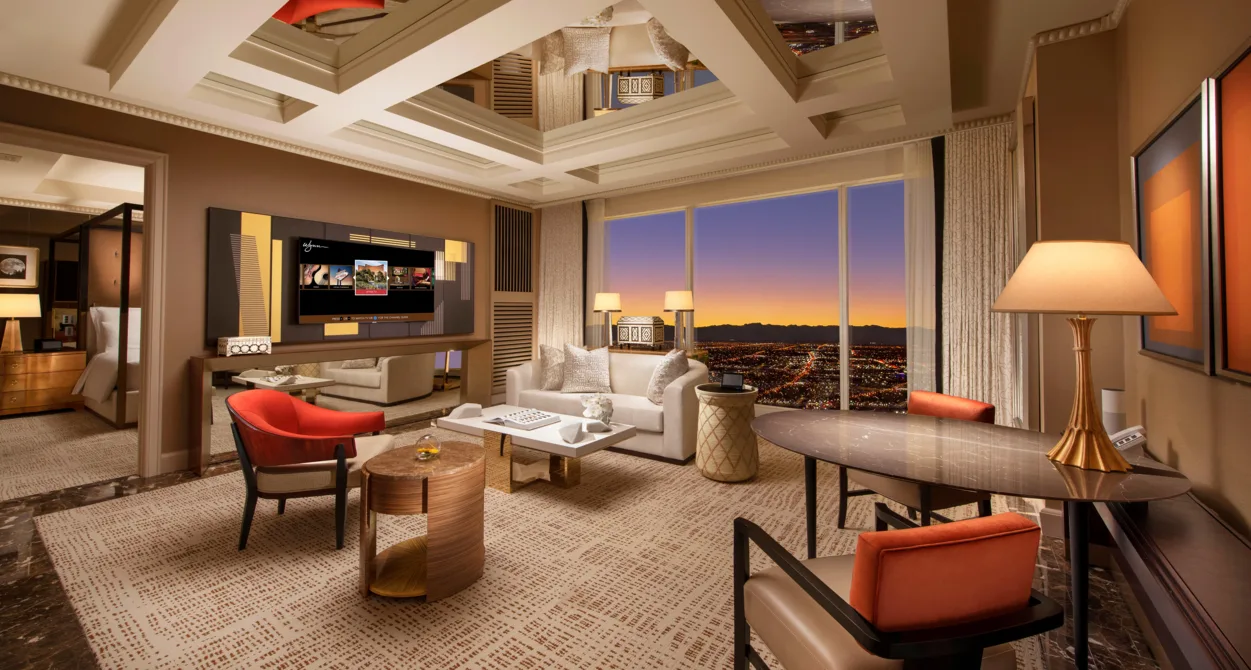 The living area of the Parlor Suite with a window overlooking Las Vegas at dusk.