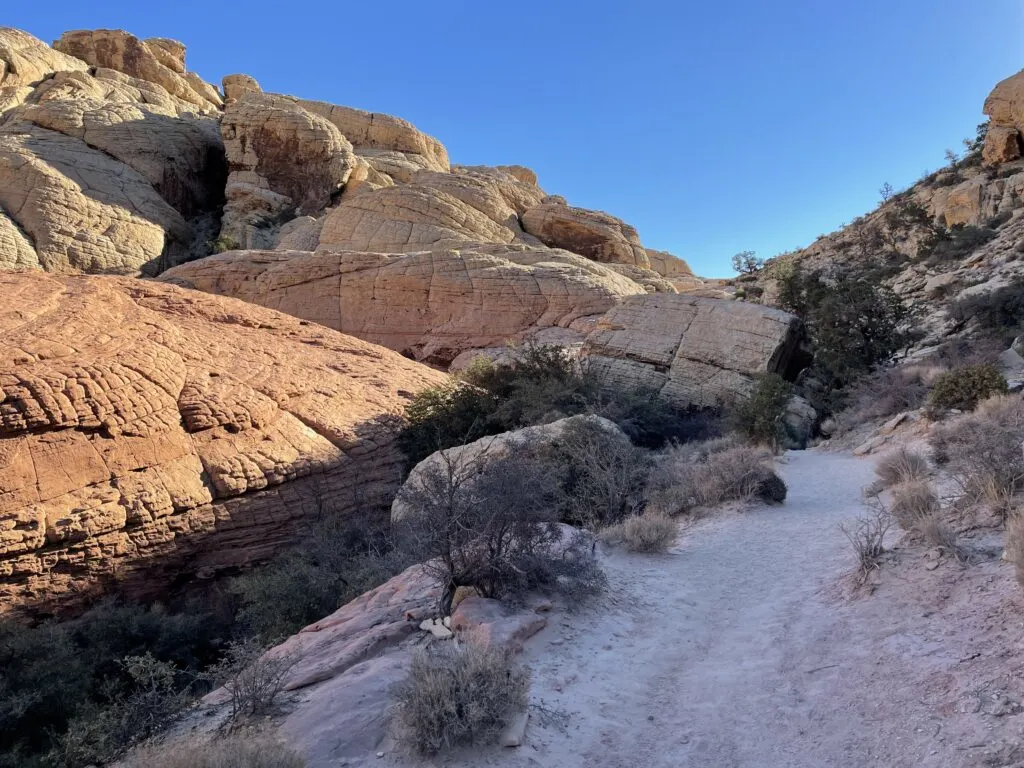 Large rock formation to the left of the winding trail