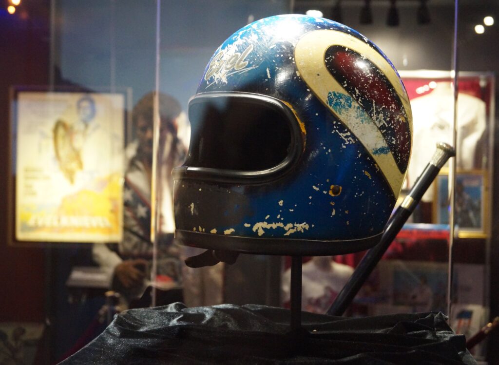 A used helmet in a display case.