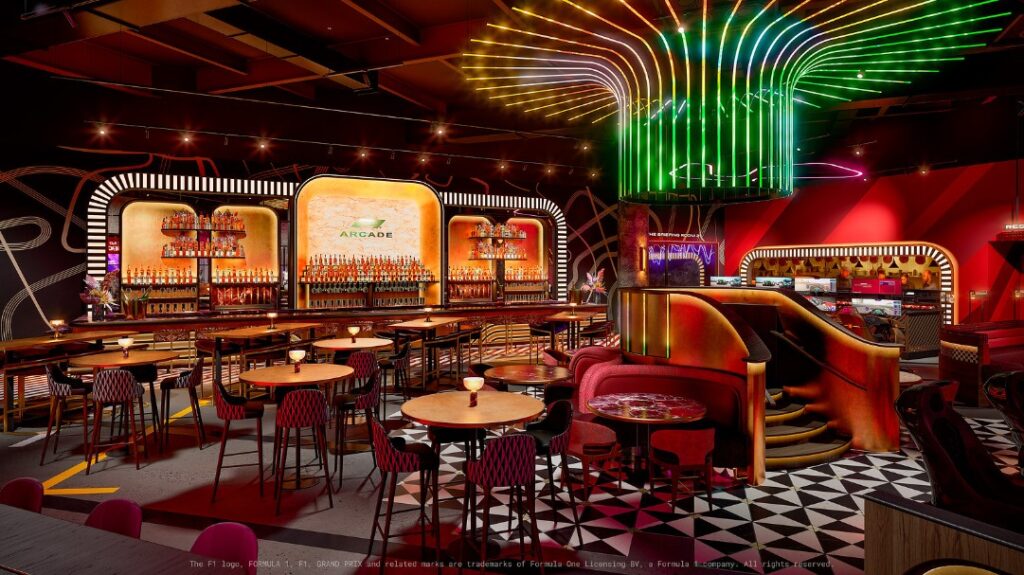 A lounge with a multicolored chandelier as it's centerpiece .