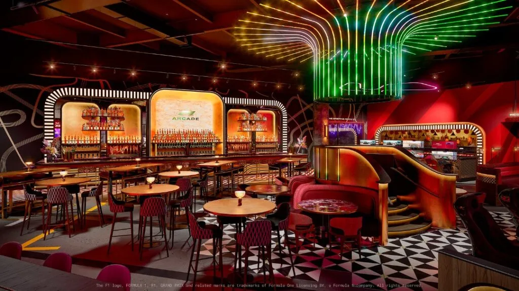 A lounge with a multicolored chandelier as it's centerpiece .