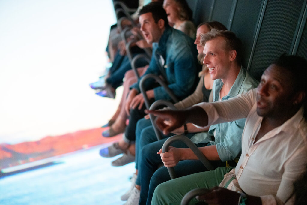 Riders seated in FlyOver Vegas ride