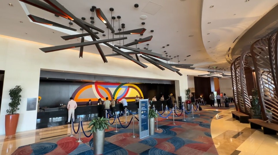 Vdara's hotel lobby, with a decorative wooden chandelier hanging above. 