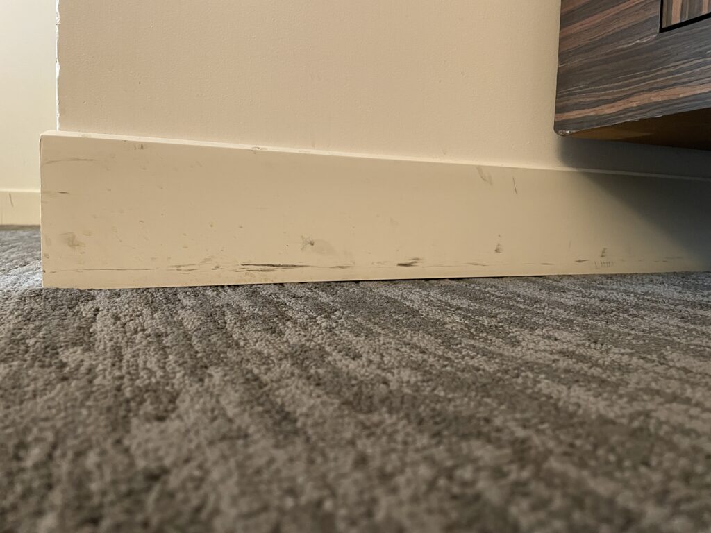 Scuffs on a white baseboard