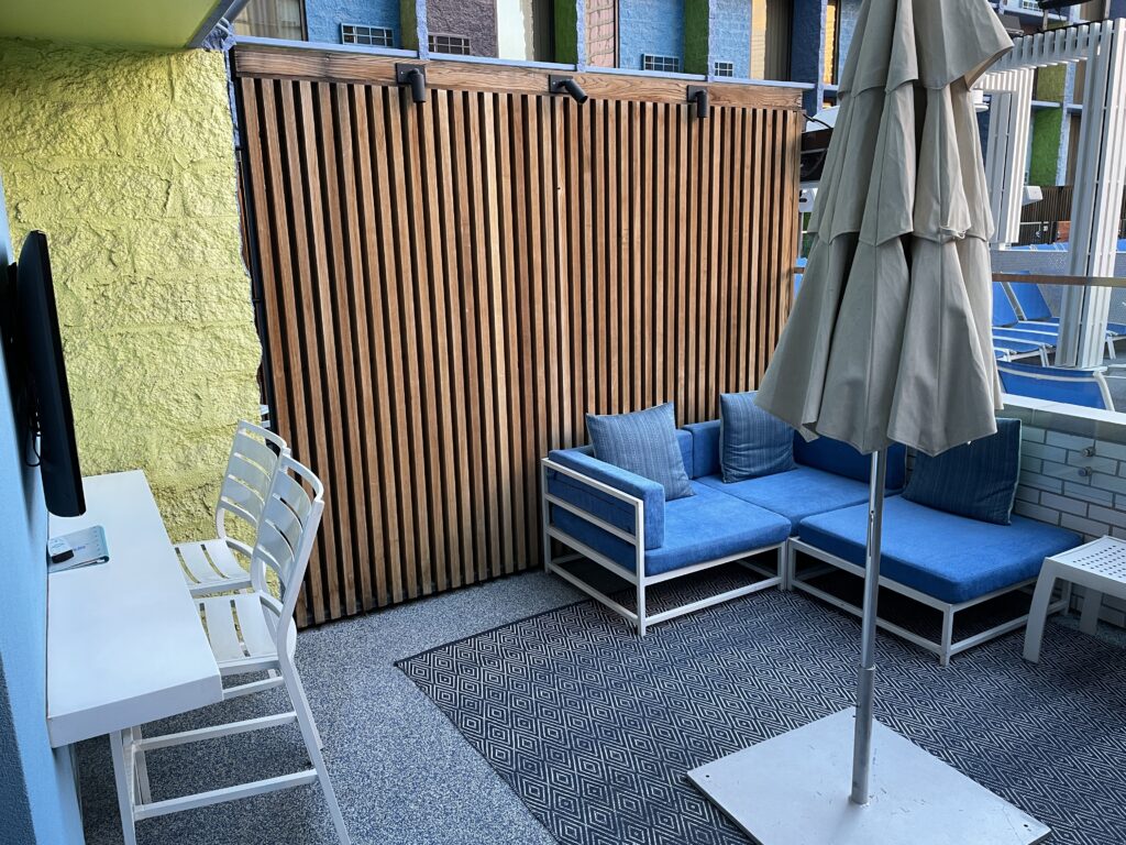 Angle showing the cabana patio with a couch and sun umbrella