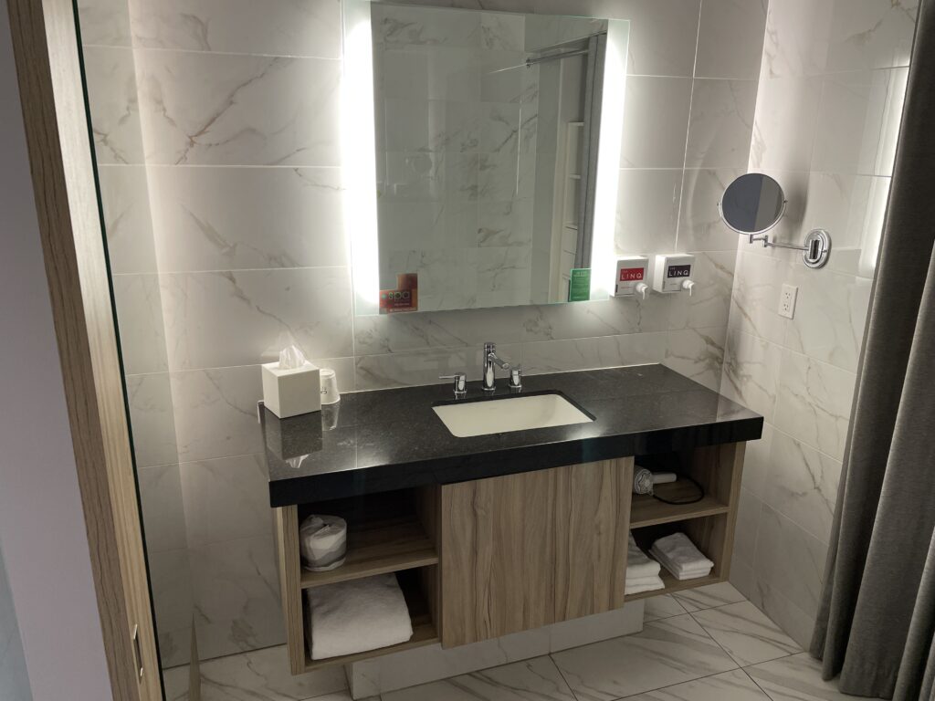 Single sink vanity and backlit mirror