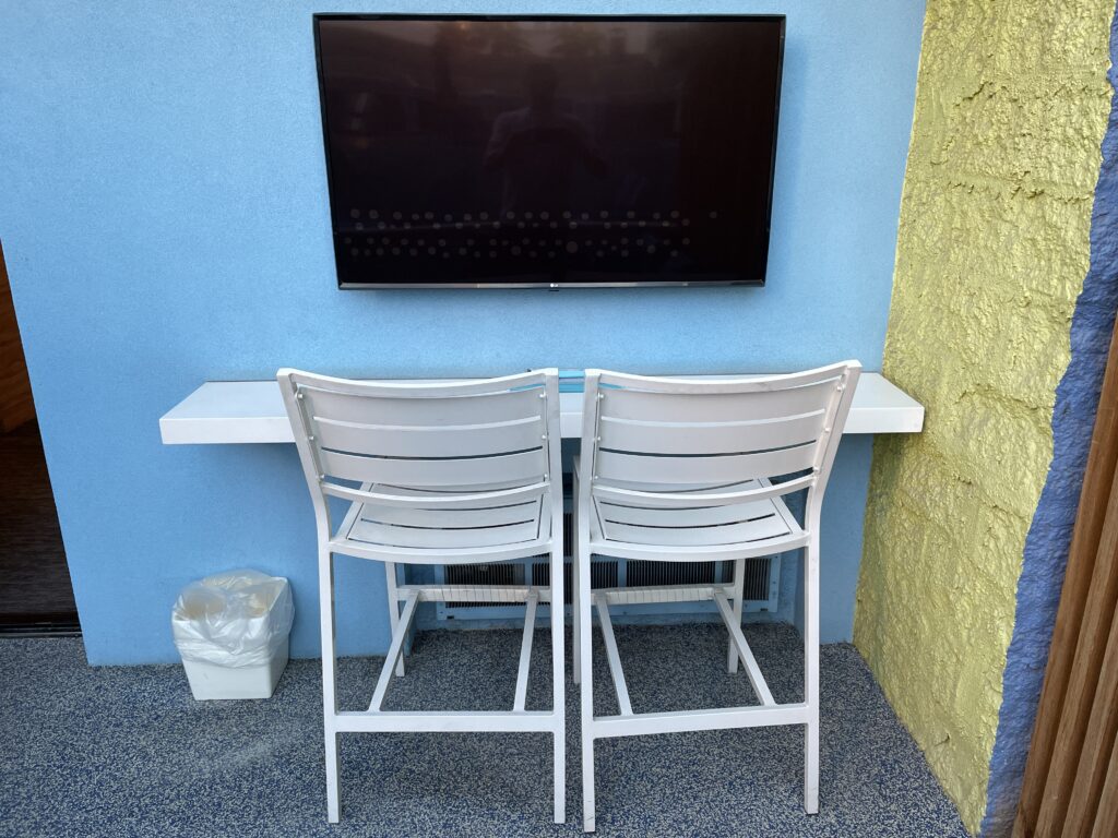 2 chairs and outdoor TV on the cabana patio