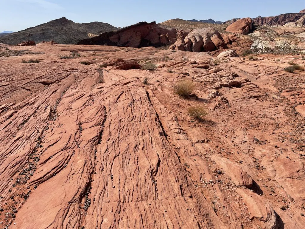 Trail continues along a flat red rock formation