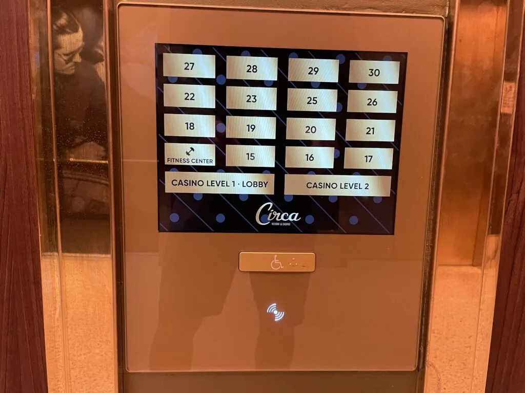 Elevator lobby menu with a digital screen and floor numbers for buttons