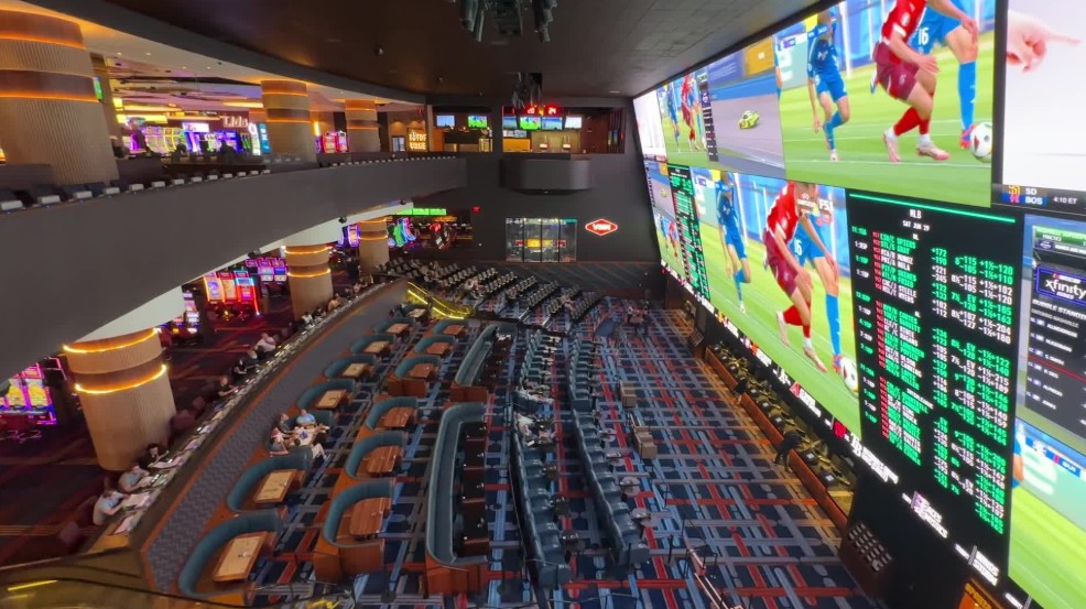 A side provile of the sportsbook that shows seating pointed at the big screen. 