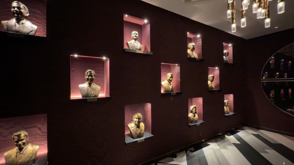 Bronze statues of vegas icons, illuminated. 