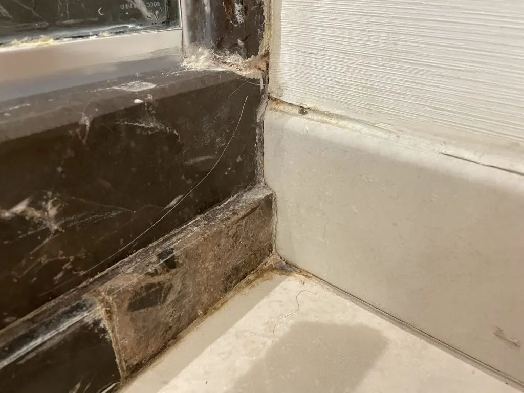 A corner in the bathroom that isn't the cleanest